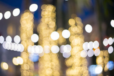 Defocused image of illuminated christmas lights at night