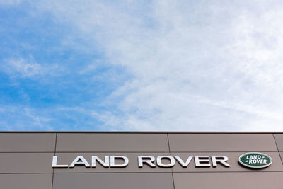 Low angle view of text on building against sky