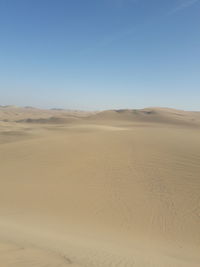 Scenic view of desert against clear sky