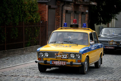 Yellow car on street in city