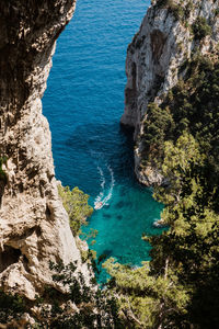 High angle view of rocks and a boat at capri bay in italy.