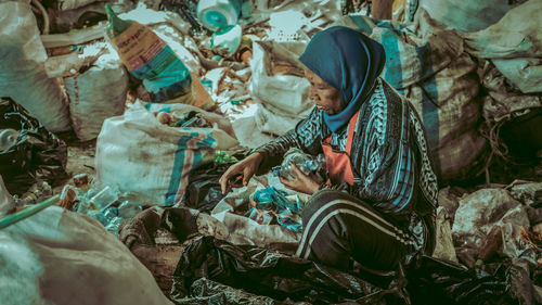 A female worker recycles plastic bottle waste at the plastic waste management site in malang city. 