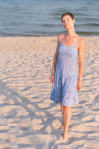 Young woman standing at beach