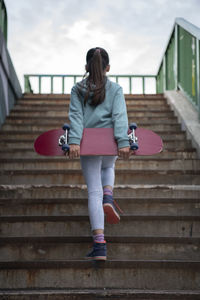 Rear view of woman on staircase