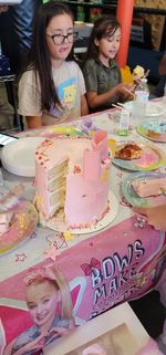 Full length of a smiling girl on table