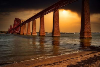 View of bridge over sea during sunset