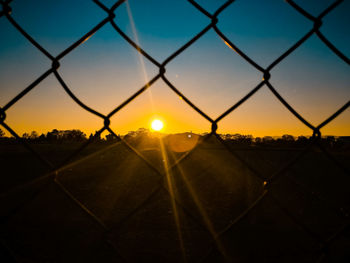 Close-up of silhouette field against sky during sunset