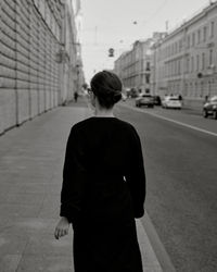 Rear view of man walking on street