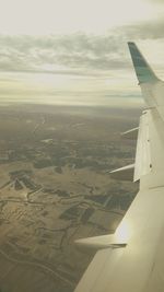 Cropped image of airplane flying over landscape