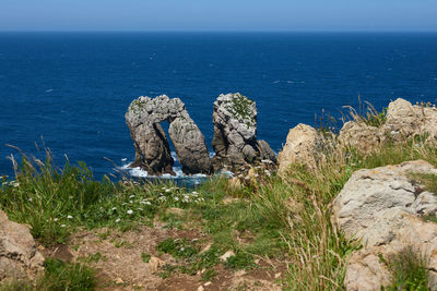 A beautiful view of whimsical rock formations on cliffs in northern spain.