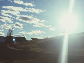 Scenic view of bright sun shining through clouds