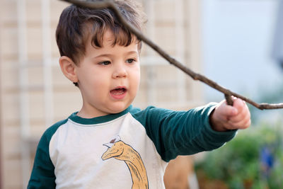 Cute little boy playing in the backyard