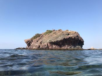 Scenic view of sea against clear blue sky