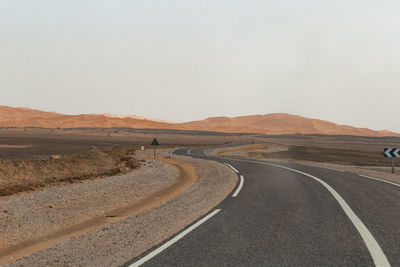 Empty road against clear sky