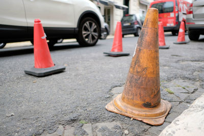 Close-up of traffic cones on road in city