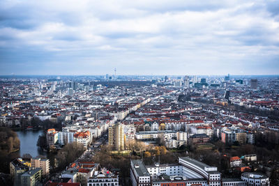 High angle view of cityscape against cloudy sky