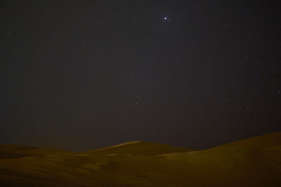 Low angle view of mountain against sky at night