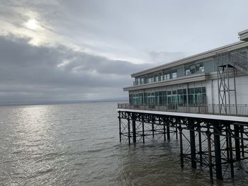 Building by sea against sky