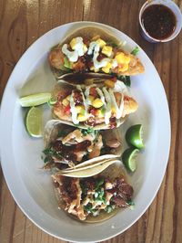High angle view of tacos served in plate on table