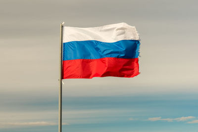 Low angle view of flag against the sky