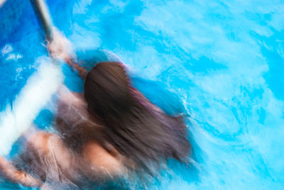 High angle view of woman swimming in pool