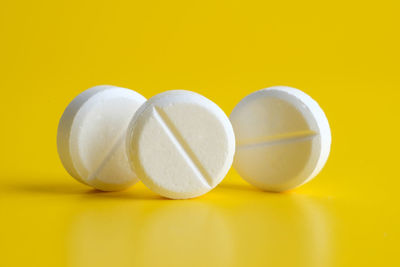 Close-up of medicine against yellow background