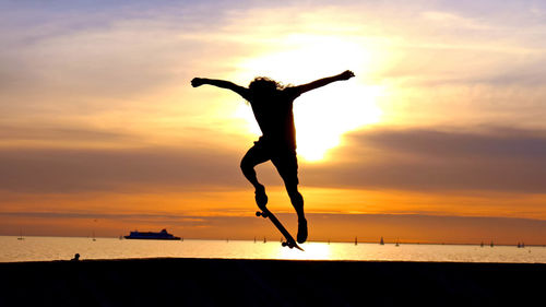 Silhouette of people enjoying at beach