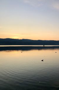 Scenic view of lake against sky during sunset