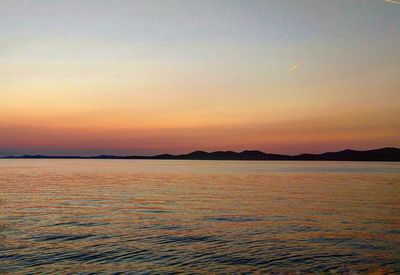 Scenic view of sea against sky at sunset