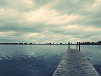 Pier over lake against sky