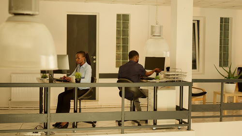 Side view of business colleagues working in office