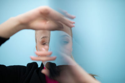 Midsection of woman with arms raised