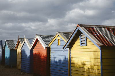 Row of beach huts against sky