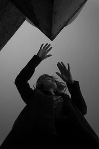 Low angle view of woman against sky