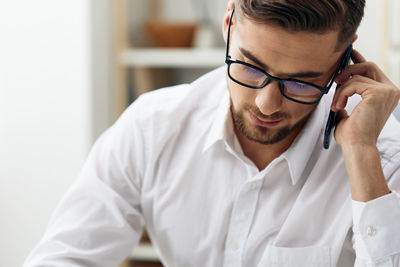 Businessman talking on smart phone at office