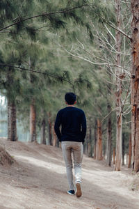 Man walking on road in forest