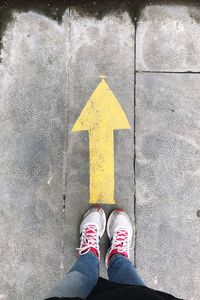 Low section of man standing on road