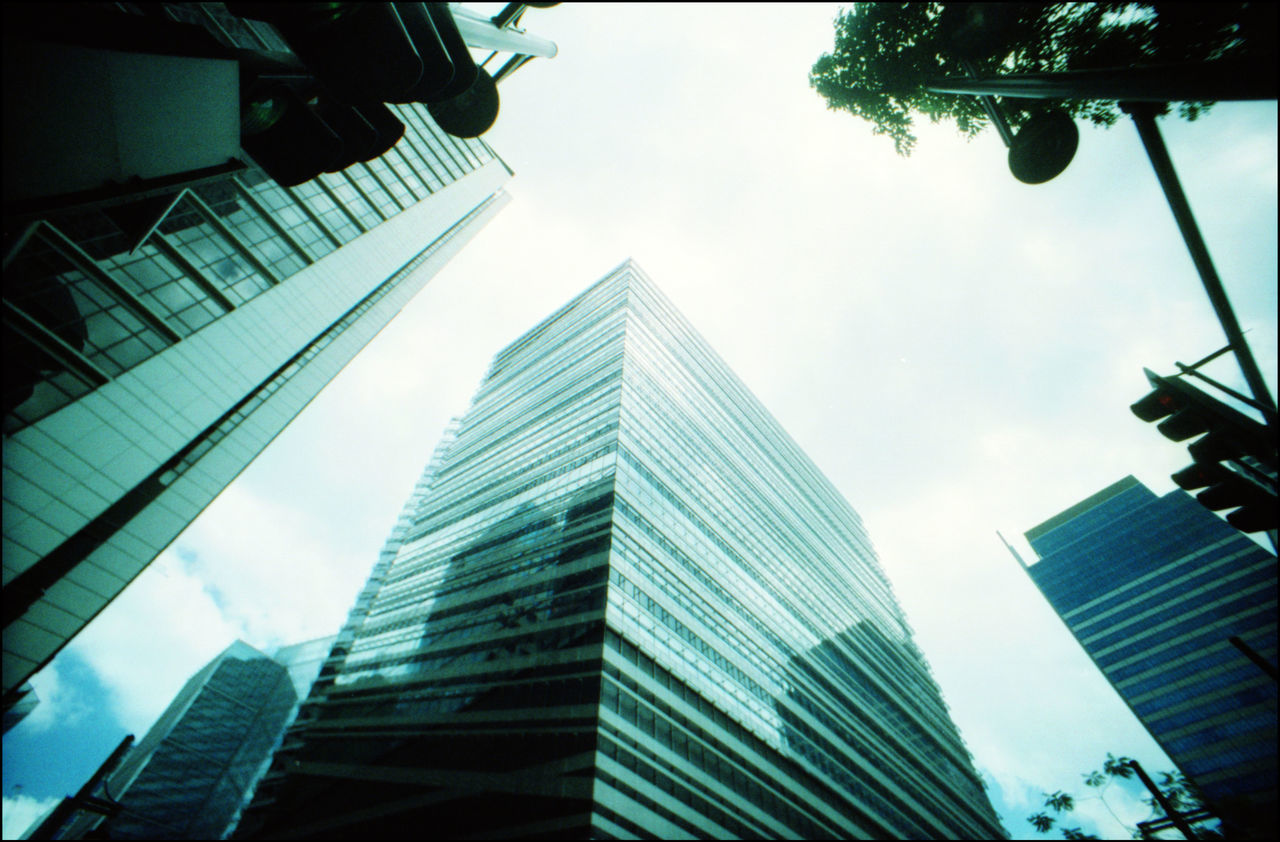 DIRECTLY BELOW SHOT OF MODERN BUILDINGS AGAINST SKY