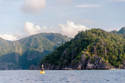 Scenic view of sea and mountains against sky at coron, palawan, philippines 