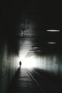 Man in illuminated tunnel