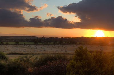 Scenic view of field against sky during sunset