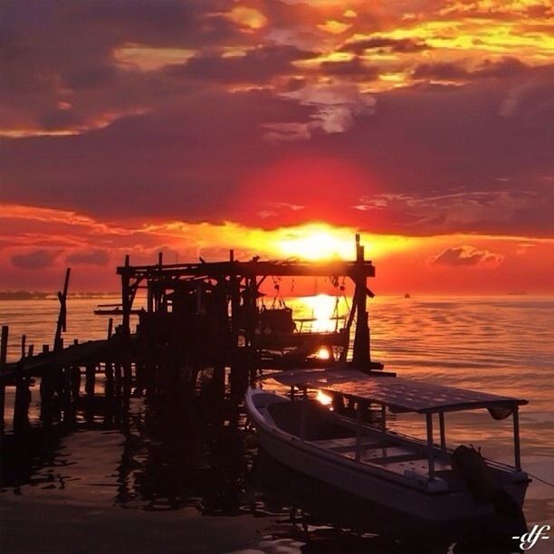 sunset, sea, water, sky, orange color, transportation, cloud - sky, silhouette, horizon over water, nautical vessel, pier, mode of transport, scenics, built structure, dramatic sky, beauty in nature, beach, boat, harbor, moored