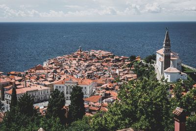 High angle view of houses and buildings in town by sea