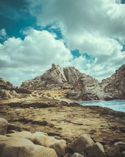 Scenic view of sea and mountains against sky