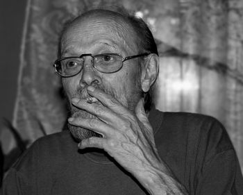 Close-up portrait of man wearing eyeglasses at home