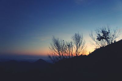Silhouette landscape against clear sky during sunset