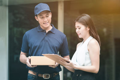 Young couple holding a smiling while standing in box