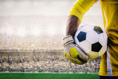 Man holding ball on soccer field