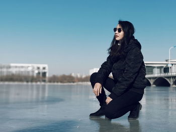 Young woman looking away in water