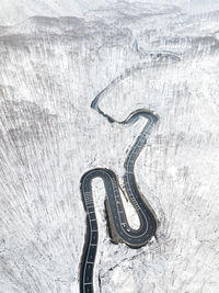 Aerial view of road on snow covered land during winter